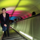 A Metro passenger stares at colored lights projected on the ceiling of the south entrance escalator tunnel of the Dupont Circle Metro station in Washington, D.C., March 16, 2000.